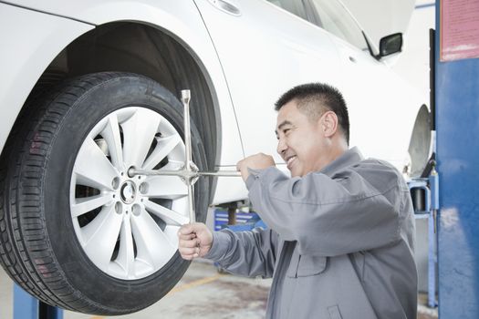 Mechanic Adjusting Tire