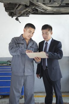 Mechanic Explaining to Businessman