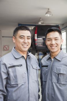 Portrait of Two Garage Mechanics