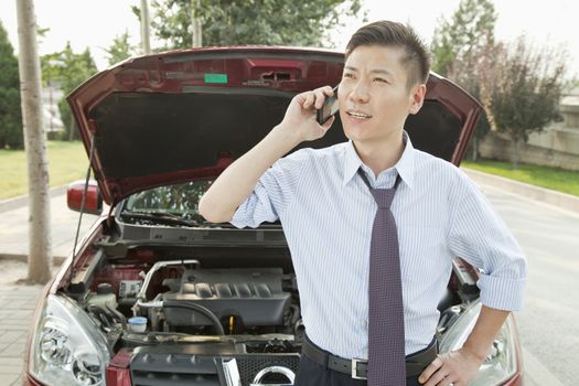 Businessman Calling for Roadside Assistance