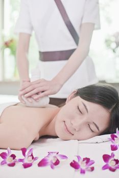 Women Receiving Herbal Massage