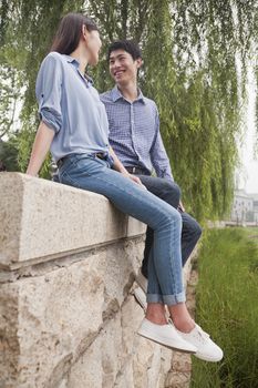 Young Couple Looking at Each Other by a Canal