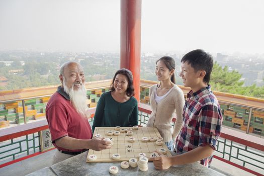 Chinese Family Playing Chinese Chess (Xiang Qi)