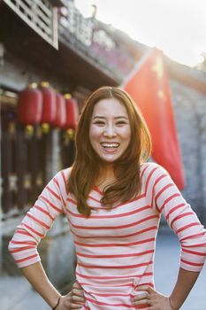 Portrait Of Smiling Young Woman In Houhai, Beijing
