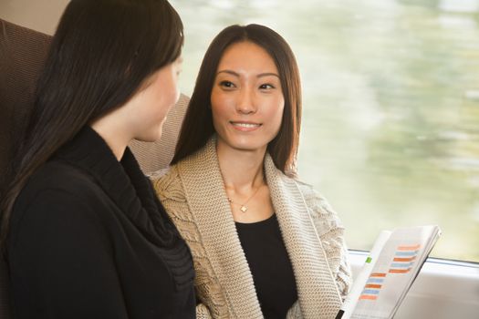 Two Women Talking on a Train