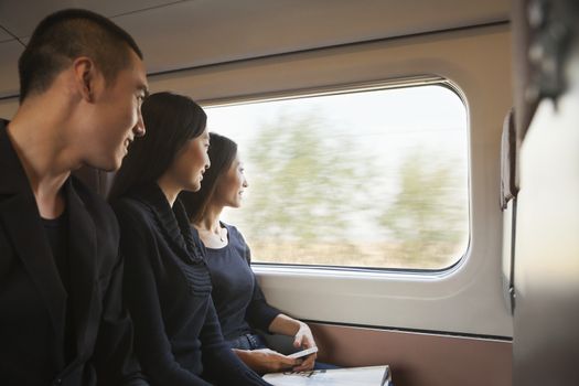 Three Friends Looking Out Train Window