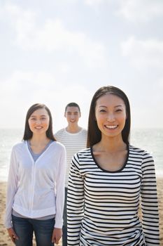 Portrait of Young Woman and Friends at the Beach