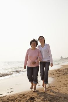 Grandmother and Granddaughter Taking a Walk by the Beach