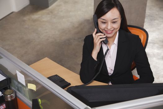 Mid adult businesswoman on the phone in the office