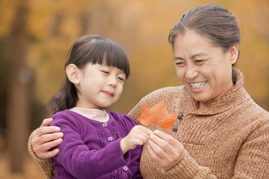 Grandmother and granddaughter in park