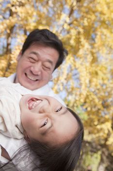 Grandfather and Granddaughter Playing in the Park