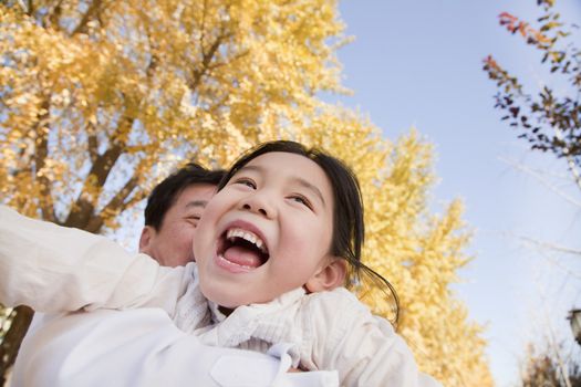 Grandfather and Granddaughter Playing in the Park