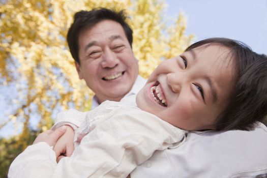 Grandfather and Granddaughter Playing in the Park