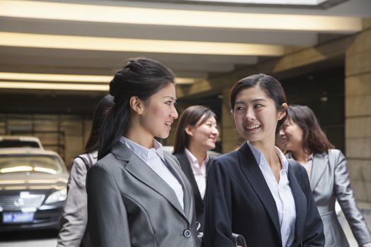 Five young Businesswomen talking in the parking garage