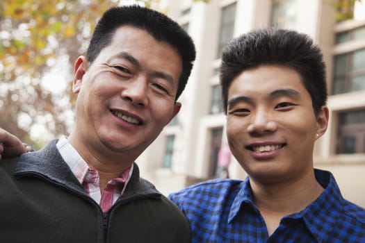 Father and son portrait in front of dormitory