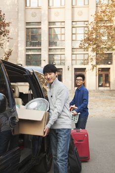 Students moving into dormitory on college campus