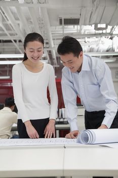 Coworkers analyzing architecture project in the office