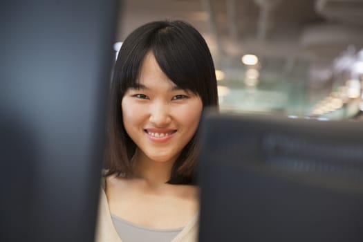 Young Business Woman Smiling at Camera in the Office