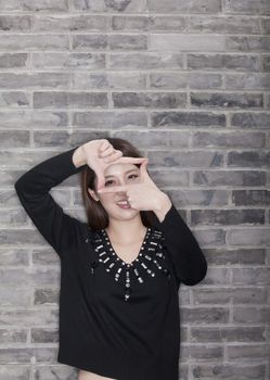 Young Woman Making Finger Frame with Hands