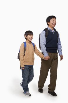 Father and son holding hands and walking