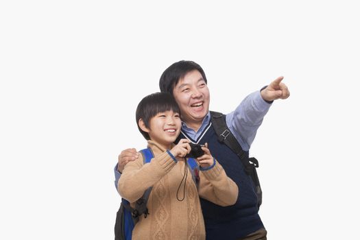 Father pointing with son holding digital camera