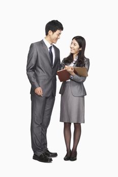 Businessman and businesswoman looking at each other