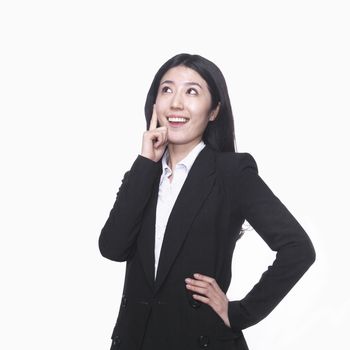 Businesswoman with hand on chin thinking