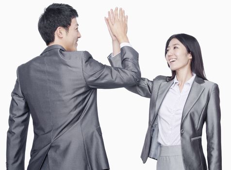 Businessman and businesswoman with hands against each other