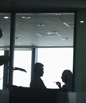 Two co-workers talking in office