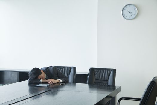 Businessman sleeping in office room