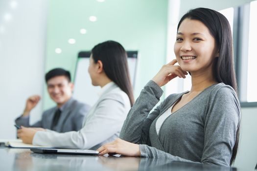 Businesswoman Looking At Camera in a Meeting