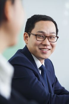 Businessman Smiling at Colleague