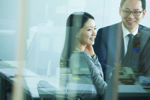 Colleagues Meeting in Conference Room, Shot Through Glass