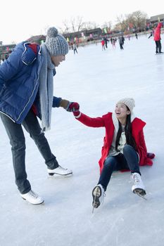 Young couple at ice rink