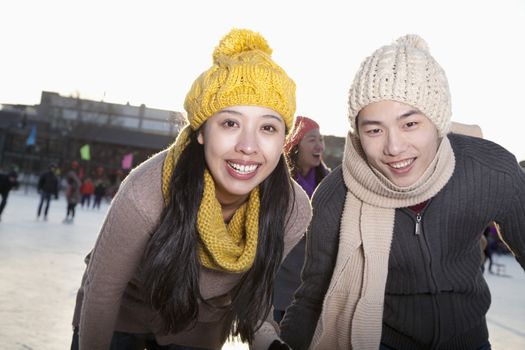 Young couple at ice rink