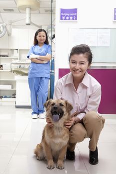 Woman with pet dog in veterinarian's office