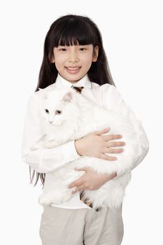 Portrait of girl in white holding a white cat