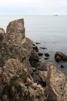 Summer landscape with big stones on shore near sea
