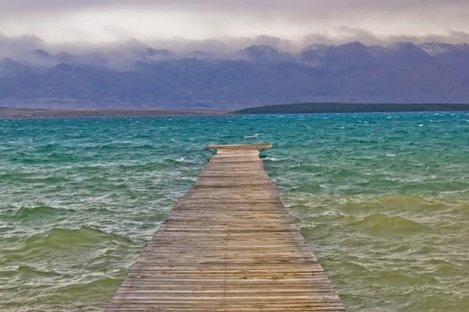 Rough sea and foggy mountain wooden boardwalk, Velebit mountain, Croatia