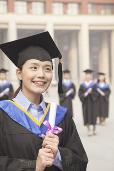 Young Female Graduate Holding Diploma