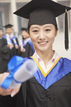 Young Female Graduate Holding Diploma