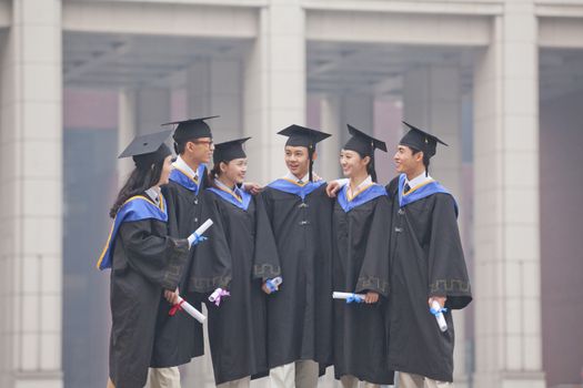 Group of Graduate Students Standing Together with Diplomas