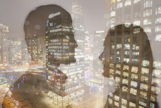 Double exposure of young couple over night cityscape 