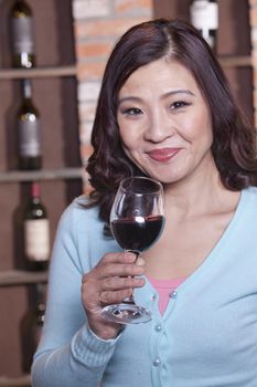 Mature Woman Holding a Glass of Wine