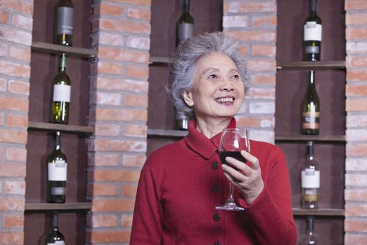 Senior Woman Holding Glass of Wine, Portrait