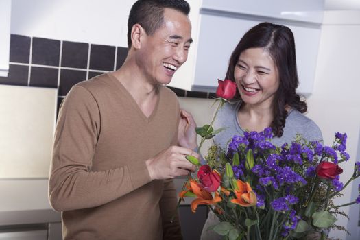 Mature Couple with Bouquet of Flowers, Man Holding a Rose