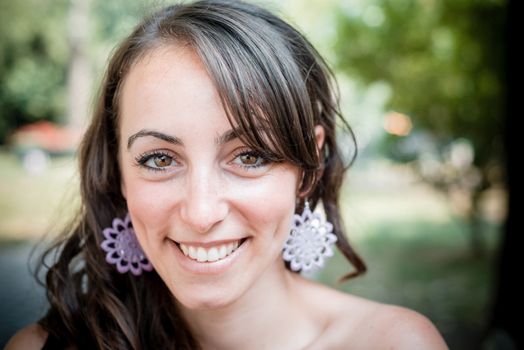 closeup portrait of smiling beautiful woman in the city