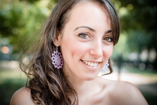 closeup portrait of smiling beautiful woman in the city