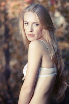 Portrait of the beautiful lady in lingerie outdoors on a natural background