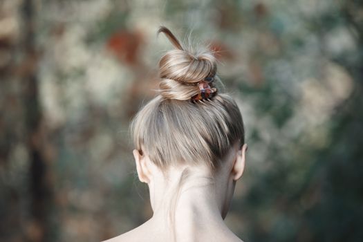 Rear view on the head of young woman outdoors